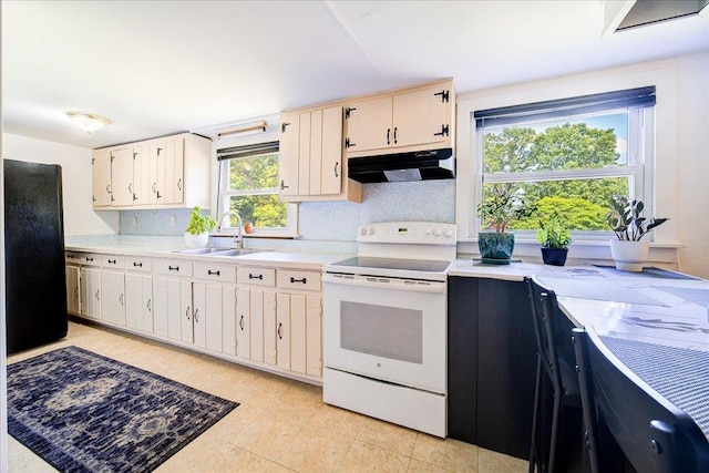 18 Gerow Ln, Cornwall, NY 12553 - kitchen featuring white electric range, under cabinet range hood, a sink, light countertops, and tasteful backsplash