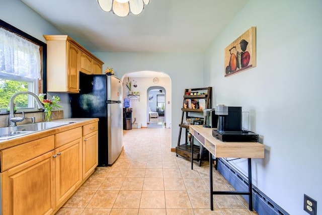18 Gerow Ln, Cornwall, NY 12553 - kitchen with a sink, arched walkways, freestanding refrigerator, light tile patterned floors, and light countertops