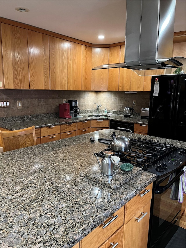 3339 Kingsland Ave, Bronx, NY 10469 - kitchen with black appliances, island exhaust hood, backsplash, and brown cabinets