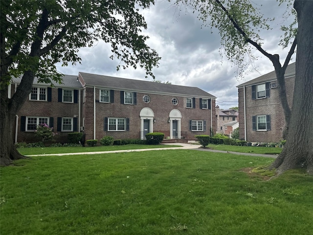 224-43A 64th Ave Unit 43A/545, Oakland Gardens, NY 11364 - colonial home featuring a front lawn and brick siding
