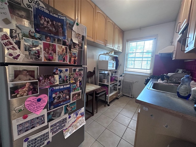 224-43A 64th Ave Unit 43A/545, Oakland Gardens, NY 11364 - kitchen featuring freestanding refrigerator, radiator heating unit, light tile patterned floors, a sink, and light countertops