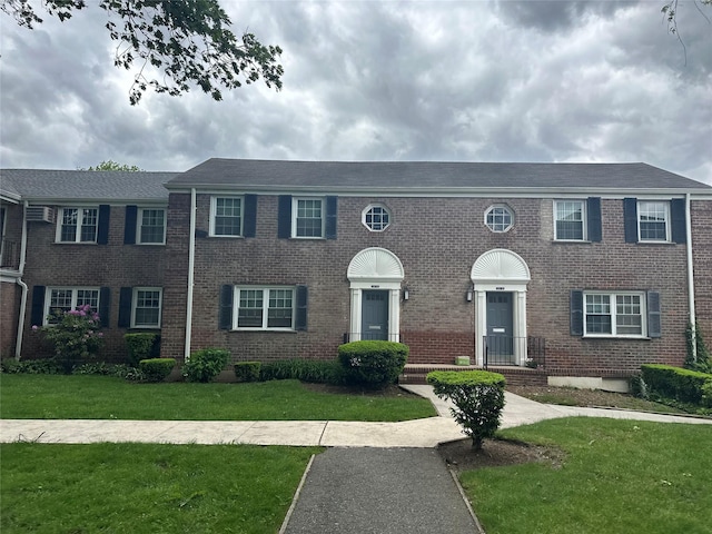 224-43A 64th Ave Unit 43A/545, Oakland Gardens, NY 11364 - colonial-style house with a front lawn and brick siding