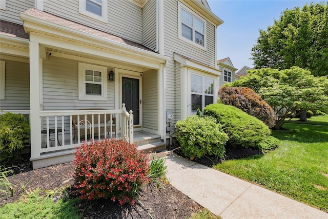 421 Cornwall Meadows Ln, Patterson, NY 12563 - property entrance featuring a porch, a shingled roof, and a lawn