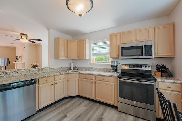 421 Cornwall Meadows Ln, Patterson, NY 12563 - kitchen with appliances with stainless steel finishes, light brown cabinets, a sink, light wood-style flooring, and ceiling fan