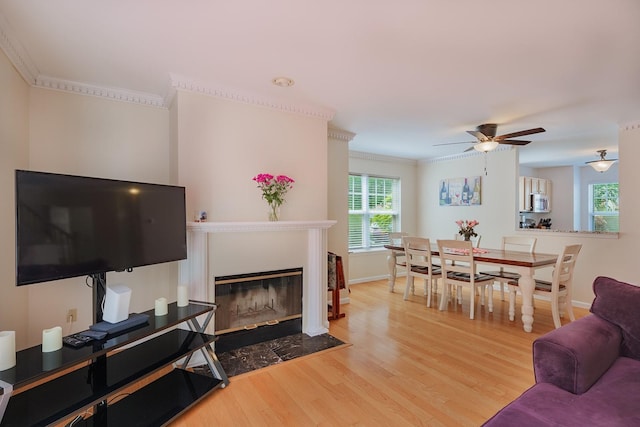 421 Cornwall Meadows Ln, Patterson, NY 12563 - living room featuring wood finished floors, ceiling fan, ornamental molding, a fireplace with flush hearth, and baseboards