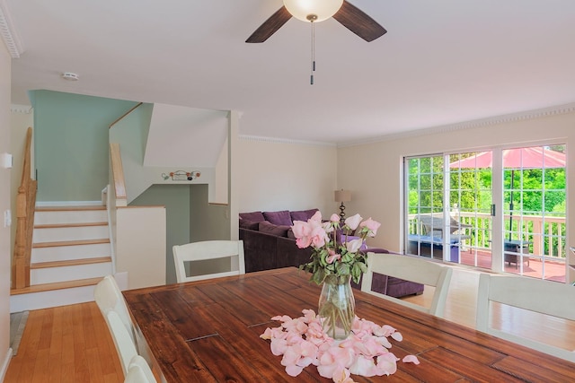 421 Cornwall Meadows Ln, Patterson, NY 12563 - dining space with stairs, a ceiling fan, wood finished floors, and ornamental molding
