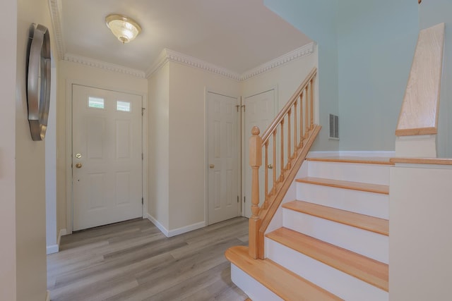 421 Cornwall Meadows Ln, Patterson, NY 12563 - entryway featuring wood finished floors, stairway, baseboards, and ornamental molding