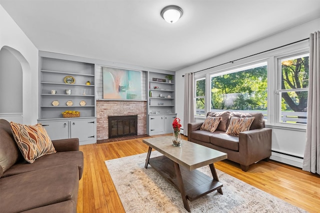 23 Johnson Ln, Millbrook, NY 12545 - living area featuring light wood-style floors, a brick fireplace, built in features, and a baseboard heating unit