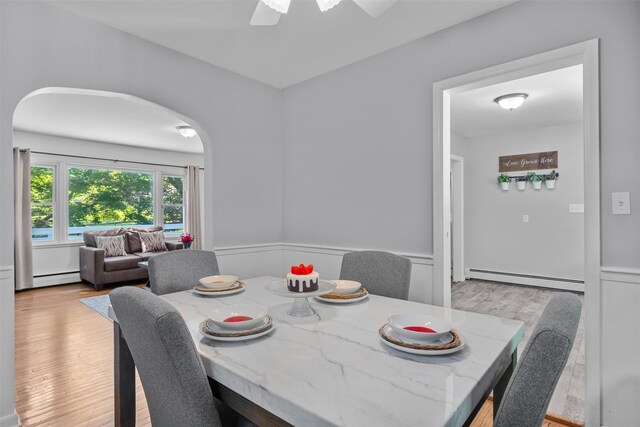 23 Johnson Ln, Millbrook, NY 12545 - dining area with a baseboard radiator, wainscoting, light wood finished floors, and ceiling fan