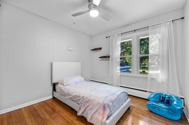 23 Johnson Ln, Millbrook, NY 12545 - bedroom featuring wood finished floors, a ceiling fan, and a baseboard radiator