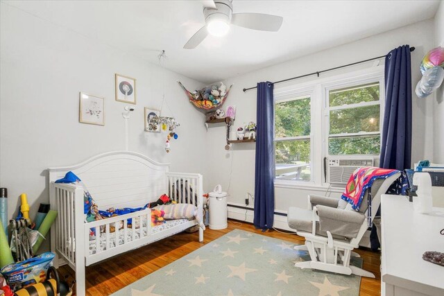23 Johnson Ln, Millbrook, NY 12545 - bedroom with multiple windows, a crib, and wood finished floors
