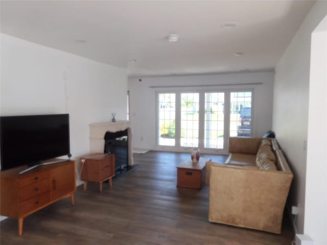 9 Adams St, East Rockaway, NY 11518 - living area with wood finished floors and a fireplace