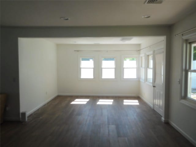 9 Adams St, East Rockaway, NY 11518 - empty room featuring plenty of natural light, wood finished floors, and baseboards