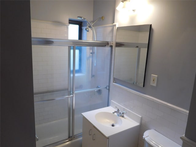 9 Adams St, East Rockaway, NY 11518 - bathroom with toilet, vanity, tile walls, and wainscoting