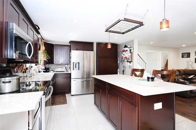 33 Highview Ln, Ridge, NY 11961 - kitchen featuring appliances with stainless steel finishes, light countertops, light tile patterned floors, open floor plan, and recessed lighting