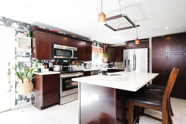 33 Highview Ln, Ridge, NY 11961 - kitchen featuring stainless steel appliances, light countertops, light tile patterned floors, hanging light fixtures, and recessed lighting