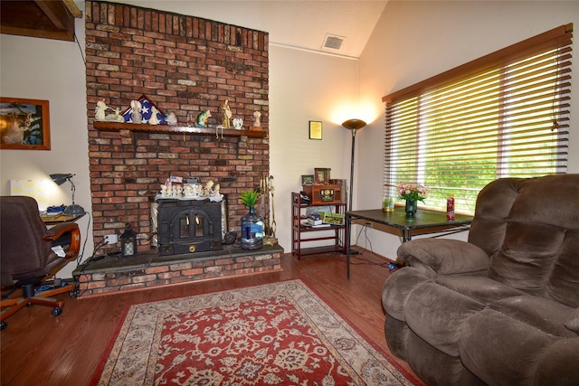 62 Crystal Rock Ct, Middle Island, NY 11953 - living room with a wood stove, lofted ceiling, and wood finished floors