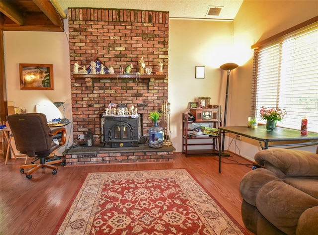 62 Crystal Rock Ct, Middle Island, NY 11953 - living room featuring a wood stove and wood finished floors