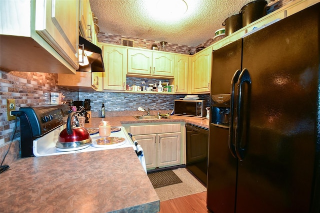 62 Crystal Rock Ct, Middle Island, NY 11953 - kitchen with black fridge, stainless steel microwave, dishwasher, a textured ceiling, and a sink