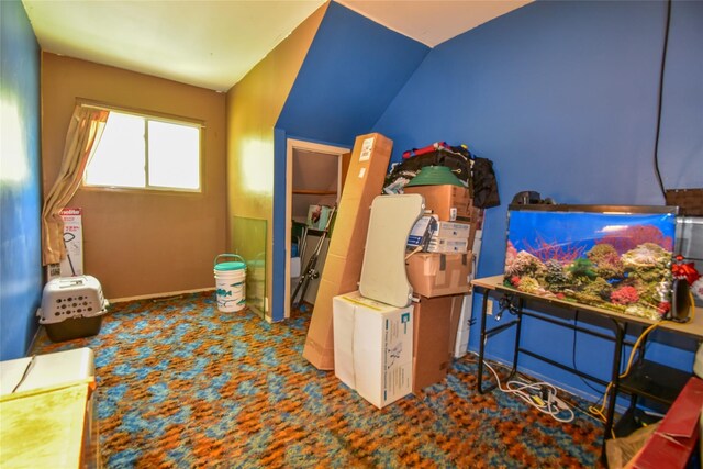 62 Crystal Rock Ct, Middle Island, NY 11953 - recreation room featuring carpet, baseboards, and lofted ceiling