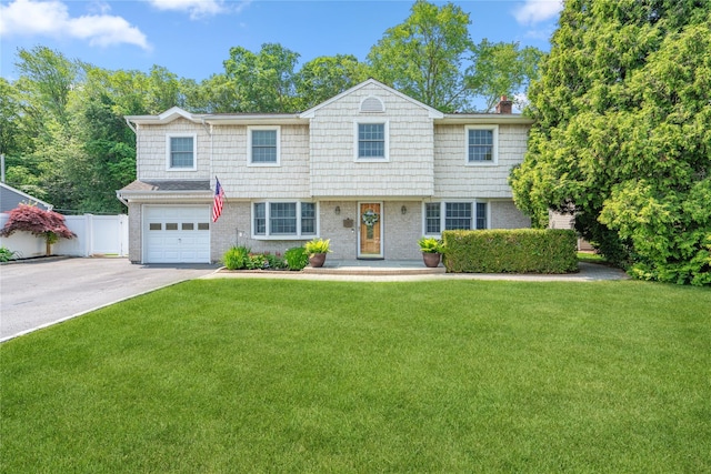 36 Richmond St, Islip, NY 11751 - view of front of property with a garage, concrete driveway, a chimney, and brick siding