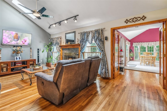 36 Richmond St, Islip, NY 11751 - living area featuring lofted ceiling, hardwood / wood-style floors, plenty of natural light, a skylight, and a glass covered fireplace