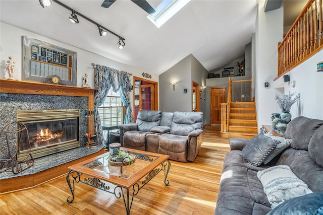36 Richmond St, Islip, NY 11751 - living room featuring stairway, a skylight, wood finished floors, vaulted ceiling, and track lighting