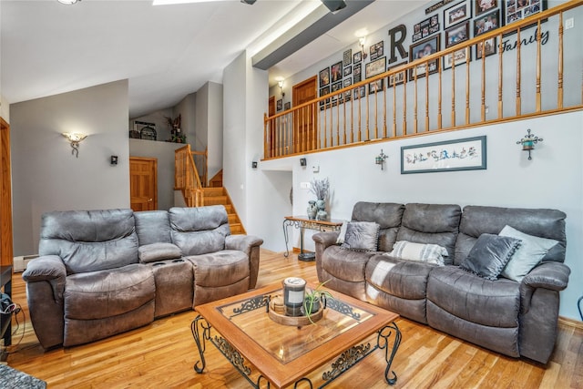 36 Richmond St, Islip, NY 11751 - living area featuring a baseboard heating unit, stairway, wood finished floors, and vaulted ceiling