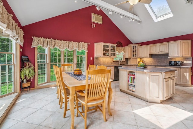 36 Richmond St, Islip, NY 11751 - kitchen with track lighting, black appliances, high vaulted ceiling, a skylight, and decorative backsplash