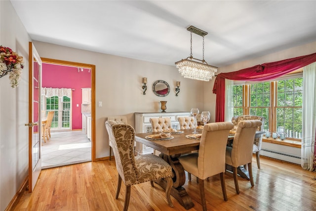 36 Richmond St, Islip, NY 11751 - dining area with healthy amount of natural light, a baseboard heating unit, a chandelier, and light wood finished floors