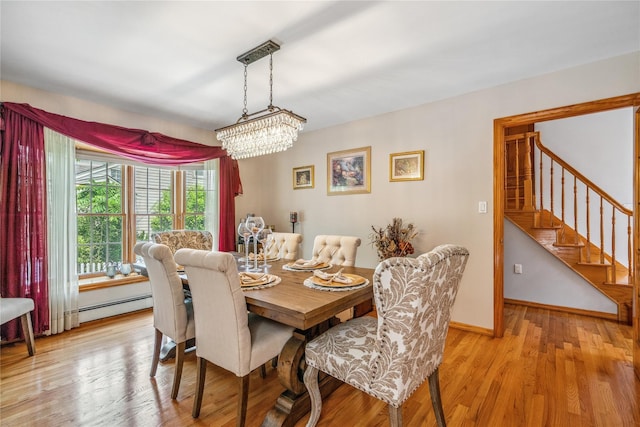 36 Richmond St, Islip, NY 11751 - dining space with a chandelier, light wood-style flooring, stairway, and baseboard heating