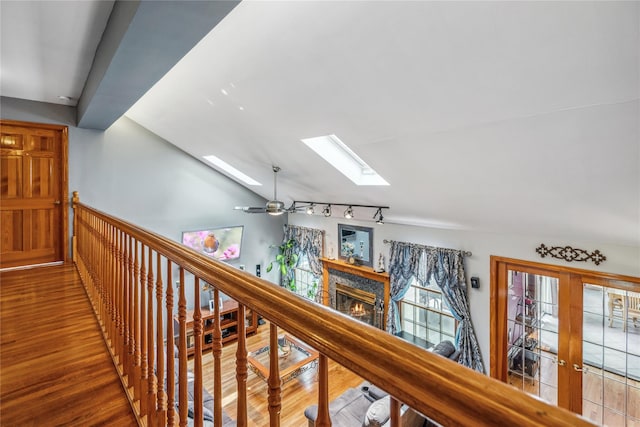36 Richmond St, Islip, NY 11751 - hall featuring a skylight, vaulted ceiling, wood finished floors, and track lighting