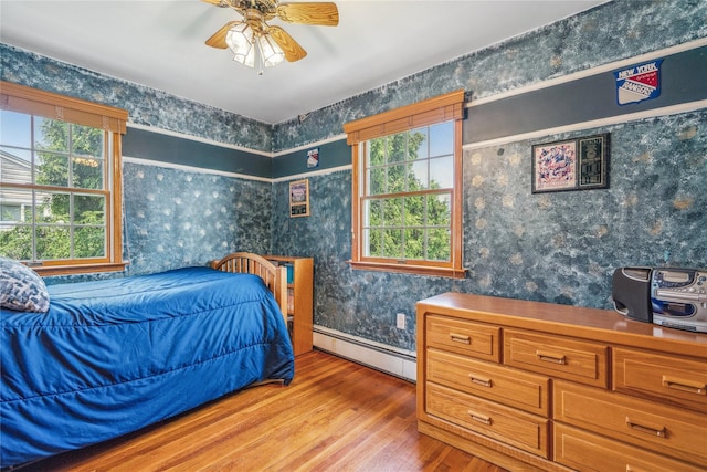 36 Richmond St, Islip, NY 11751 - bedroom with a baseboard radiator, wood finished floors, and wallpapered walls