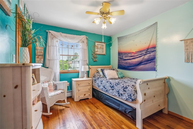 36 Richmond St, Islip, NY 11751 - bedroom with hardwood / wood-style floors, a baseboard radiator, and a ceiling fan