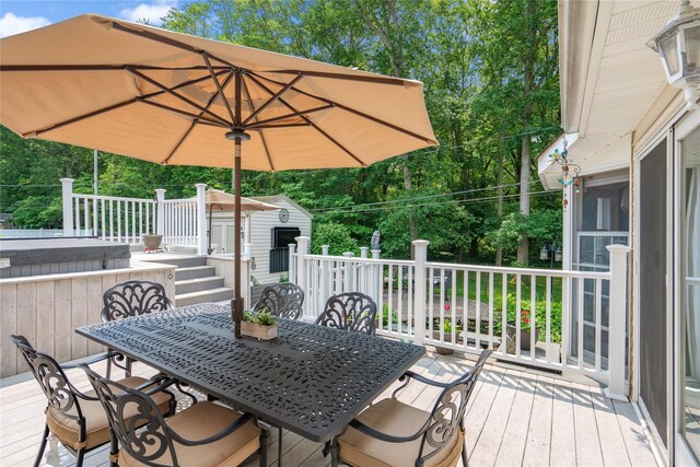 36 Richmond St, Islip, NY 11751 - wooden terrace with a shed, outdoor dining area, and view of scattered trees