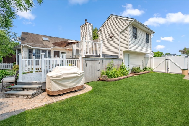 36 Richmond St, Islip, NY 11751 - rear view of house with a gate, a deck, and a chimney