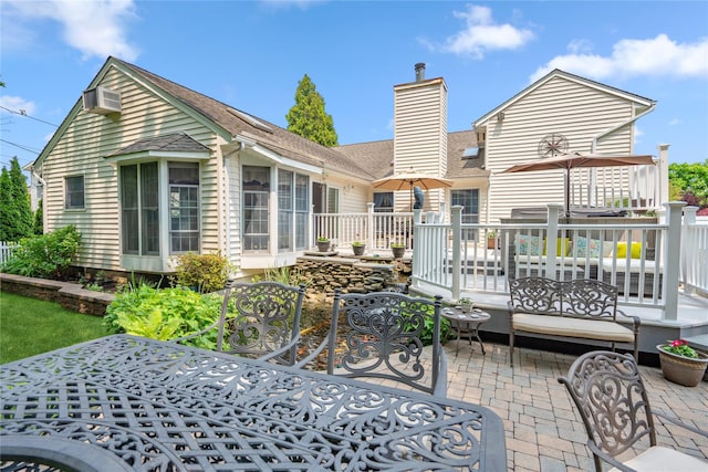 36 Richmond St, Islip, NY 11751 - back of property featuring a chimney, a wooden deck, a shingled roof, and a patio