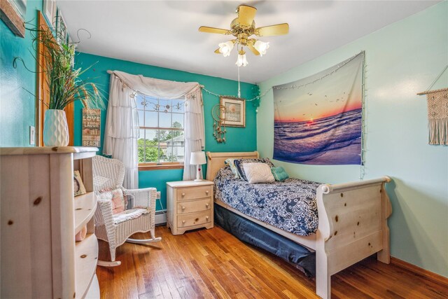 36 Richmond St, Islip, NY 11751 - bedroom with hardwood / wood-style floors, a baseboard radiator, and a ceiling fan