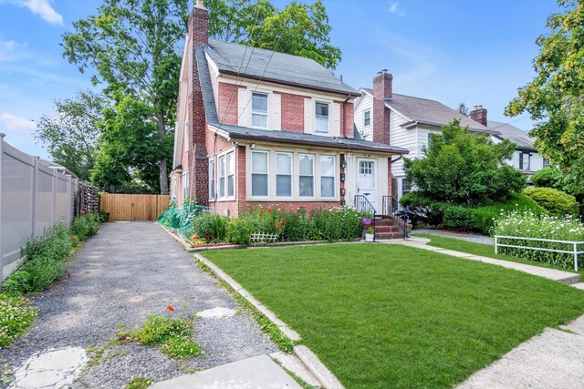 4360 Auburndale Ln, Flushing, NY 11358 - view of front of home featuring brick siding, a chimney, and driveway