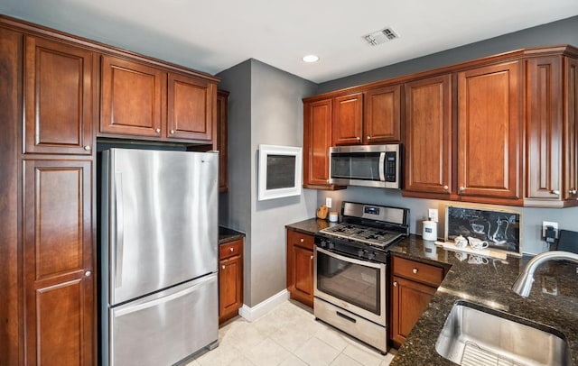494 Pacing Way Unit 301C, Westbury, NY 11590 - kitchen featuring appliances with stainless steel finishes, a sink, dark stone counters, baseboards, and recessed lighting