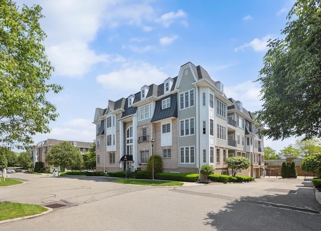 494 Pacing Way Unit 301C, Westbury, NY 11590 - view of building exterior with a residential view