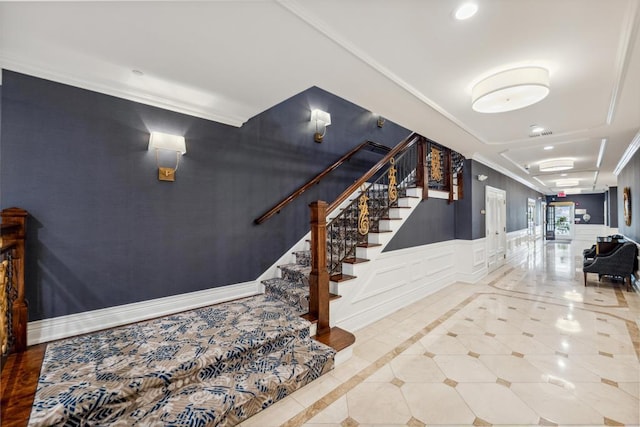 494 Pacing Way Unit 301C, Westbury, NY 11590 - staircase with crown molding, recessed lighting, a decorative wall, wainscoting, and inlaid floor details