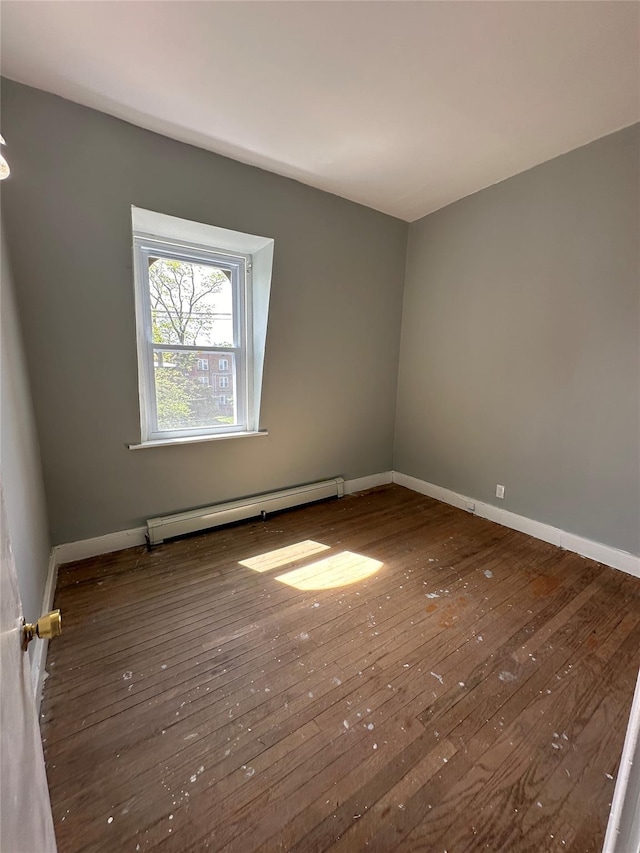 86 S Hamilton St, Poughkeepsie, NY 12601 - spare room with baseboard heating, hardwood / wood-style flooring, and baseboards