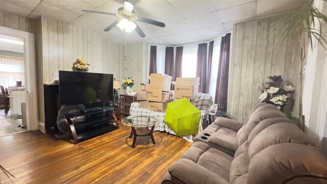 86 S Hamilton St, Poughkeepsie, NY 12601 - living room with wooden walls, a ceiling fan, and wood finished floors