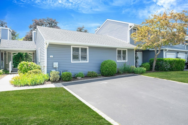 195 Alicia Dr Unit 195, North Babylon, NY 11703 - view of property exterior featuring a lawn and a shingled roof