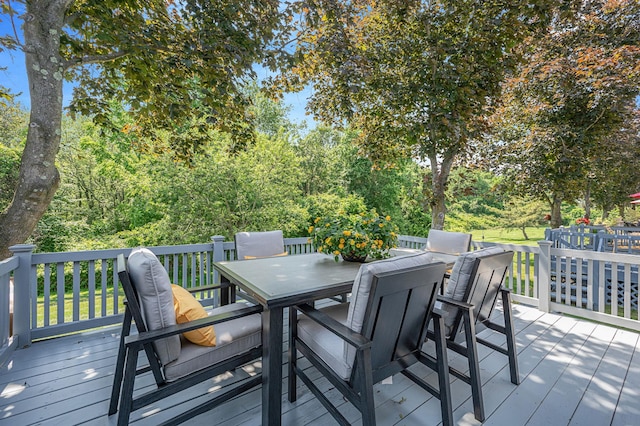 195 Alicia Dr Unit 195, North Babylon, NY 11703 - wooden deck featuring outdoor dining space and view of wooded area