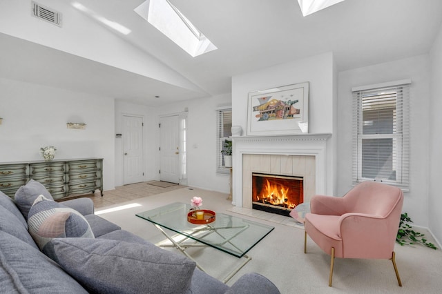 195 Alicia Dr Unit 195, North Babylon, NY 11703 - living area featuring a skylight, lofted ceiling, a tiled fireplace, and carpet flooring