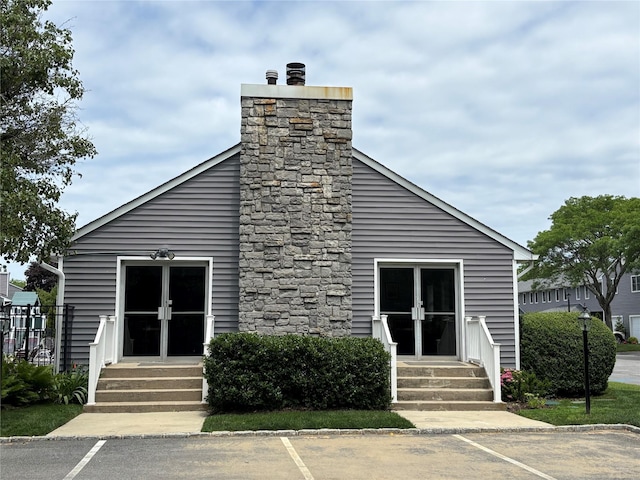 195 Alicia Dr Unit 195, North Babylon, NY 11703 - view of building exterior with entry steps and uncovered parking