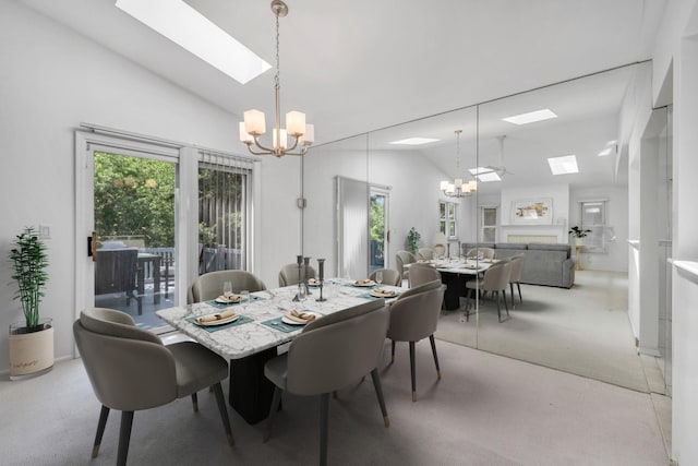 195 Alicia Dr Unit 195, North Babylon, NY 11703 - dining room featuring a chandelier, a skylight, vaulted ceiling, light carpet, and plenty of natural light
