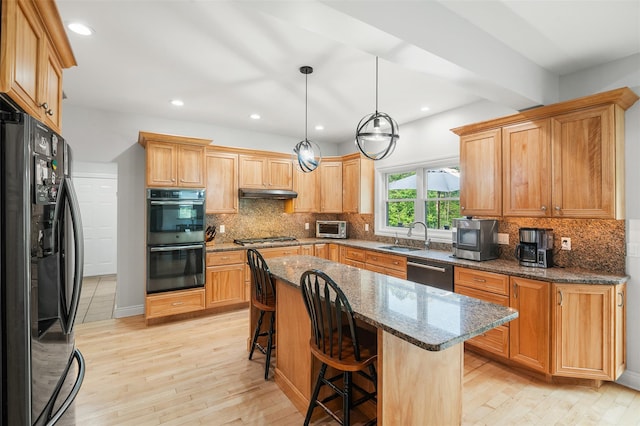 446 M And M Rd, Middletown, NY 10940 - kitchen with appliances with stainless steel finishes, a kitchen bar, light wood-style flooring, tasteful backsplash, and recessed lighting